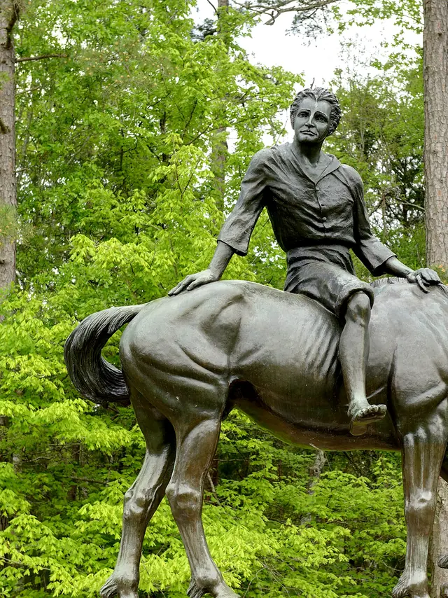 Bronze statue of a young Andrew Jackson seated on a horse among green trees at Andrew Jackson State Park near Lancaster, SC