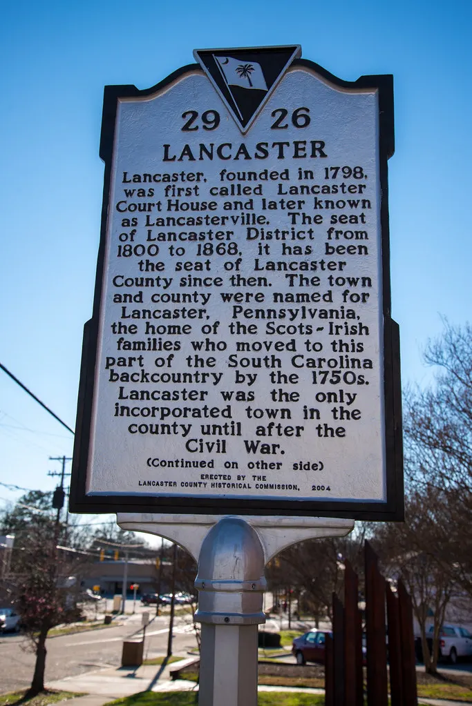 South Carolina historical marker titled Lancaster against a blue sky